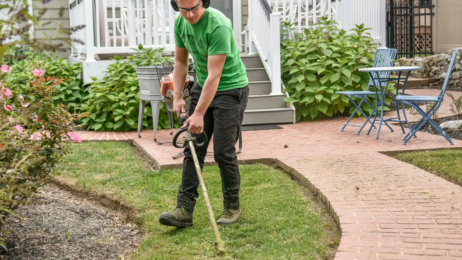 Dallas Garden Services crew member working with a shovel on a landscape install