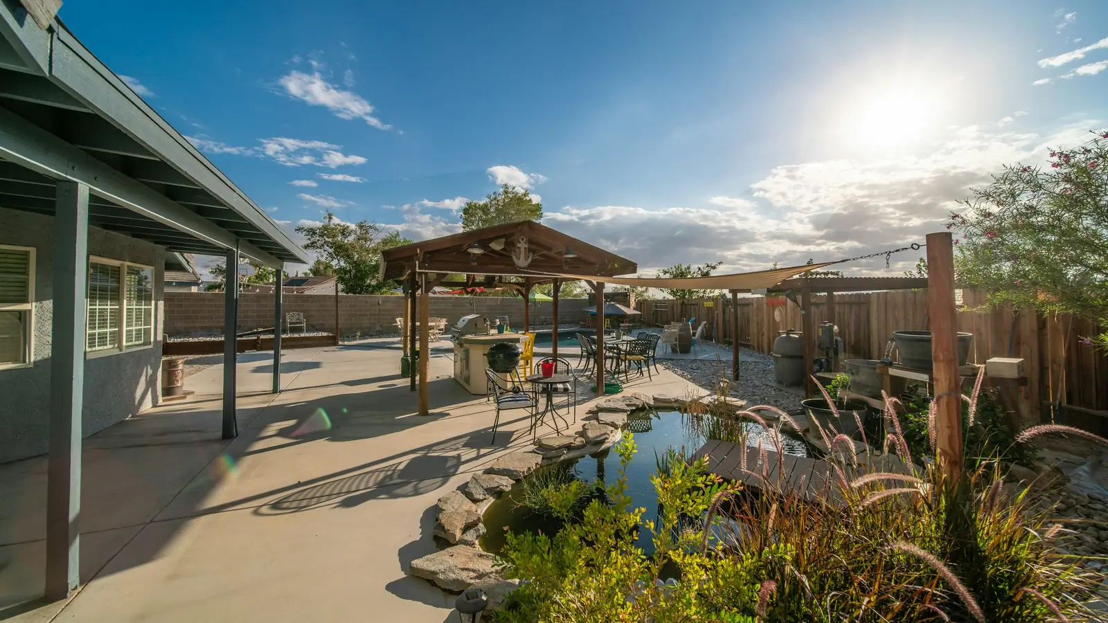Landscaped backyard with pond, gazebo and mature planting